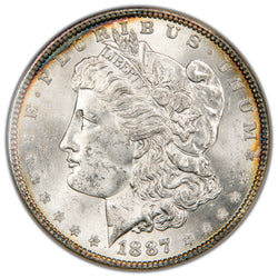 Macro photograph of the obverse on an 1887 Morgan Silver Dollar showing Liberty's profile, crisp mint luster, and original details.