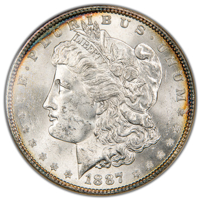 Macro photograph of the obverse on an 1887 Morgan Silver Dollar showing Liberty's profile, crisp mint luster, and original details.