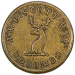 Obverse of a Ceylon 1859 A. & B. Scott & Co. Colombo Coffee Store brass 6d token (Pridmore #88, SKU: SP2888), featuring a stag's head facing centered on a scroll, surrounded by the legend A & B. SCOTT & Co. COLOMBO.