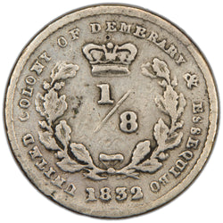 Reverse of an ungraded United Colony of Demerara & Essequibo 1832 1/8 Guilder silver coin (KM# 16, Serial/SKU: SP2970), displaying the fraction denomination "1/8" crowned within an oak wreath, surrounded by the colony legend "UNITED COLONIES OF DEMERARA & ESSEQUIBO" and date "1832".