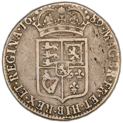 Reverse of a Great Britain 1689 William & Mary Half Crown silver coin (SCBC #3434, SKU: SP2824), displaying the crowned First Shield of Royal Arms (quarterly: England, Scotland, Ireland, and France, with Nassau on an inescutcheon) flanked by interlinked W&M monograms, with the date 1689 above and outer royal title legend.