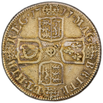Reverse of a Great Britain 1711 Queen Anne Shilling silver coin (SCBC #3610, SKU: SP2823), displaying four crowned cruciform shields (England/Scotland impaled, France, Ireland, and Hanover) surrounding a central Garter Star, divided by the date 17 11 and surrounded by the royal title legend.