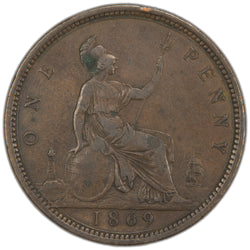 Reverse of an ungraded Great Britain 1869 1d Penny bronze coin (KM# 749, Key Date, Serial/SKU: SP2952), displaying Britannia seated right facing left, holding a trident and shield with a lighthouse and ship flanking, encircled by the legend "ONE PENNY" with the key date "1869" in the exergue.