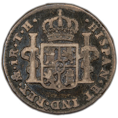 Reverse of a Spanish Colonial Mexico 1809 1 Real silver coin (Mexico City mint, SKU: SP2900), displaying the crowned shield coat of arms of Spain flanked by the Pillars of Hercules wrapped in banners, surrounded by HISPAN ET IND REX with mintmark Mo, denomination 1R, and assayer initials TH.