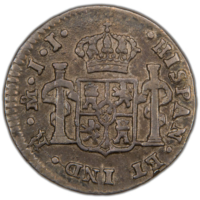 Reverse of a Spanish Colonial Mexico 1815 1/2 Real silver coin (Mexico City mint, SKU: SP2899), displaying the crowned shield coat of arms of Spain flanked by the Pillars of Hercules with PLUS ULTRA ribbons, surrounded by the legend HISPAN ET IND REX with mintmark Mo and assayer initials JJ.