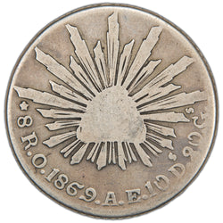 Obverse of an ungraded Mexico 1869 Ornate 69 Oaxaca 8 Reales silver coin (Serial/SKU: SP2968), featuring the Phrygian cap of liberty radiating light with the word "LIBERTAD" inscribed, surrounded by the denomination, mint mark, date, assayer initials, and fineness "8R.O.1869.E.A.10Ds.20Gs.".
