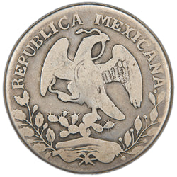 Reverse of an ungraded Mexico 1869 Ornate 69 Oaxaca 8 Reales silver coin (KM# 377.4 / Ornate "69" variety, Serial/SKU: SP2968), displaying the Mexican golden eagle perched on a nopal cactus with a snake in its beak, enclosed within an oak and laurel wreath, surrounded by "REPUBLICA MEXICANA".