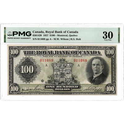 Front face view of a 1927 Royal Bank of Canada 100 dollar chartered banknote, highlighting the historical design vignettes and PMG VF-30 grading details.