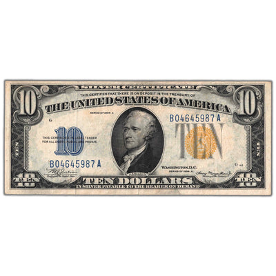 Front of an ungraded United States 1934 $10 North Africa WWII Emergency Issue Silver Certificate note (Fr. #2309, Grade VF, Serial/SKU: B04645987A), featuring a central portrait vignette of Alexander Hamilton, prominent yellow Treasury seal, blue serial number B04645987A, and yellow seal color distinction.
