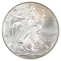 Obverse of a United States 2001 1oz $1 Silver Eagle coin (PCGS Gem UNC, SKU: WTC 050), featuring Adolph A. Weinman's full-length figure of Liberty walking draped in the American flag toward the rising sun, inscribed with LIBERTY, IN GOD WE TRUST, and the date 2001